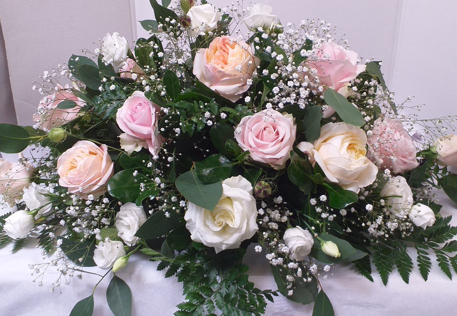 Bowl arrangement includes, pink and white roses, lisianthus and gyp