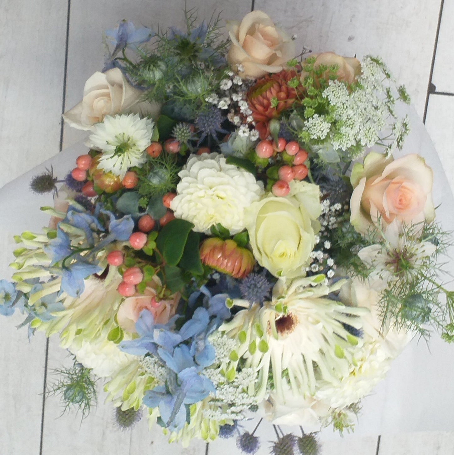 bouquet of white roses, dahlias, queen annes lace, gyp pink hypericum, orange dahlia, echinopsis, gerbera, larkspur and nigela,