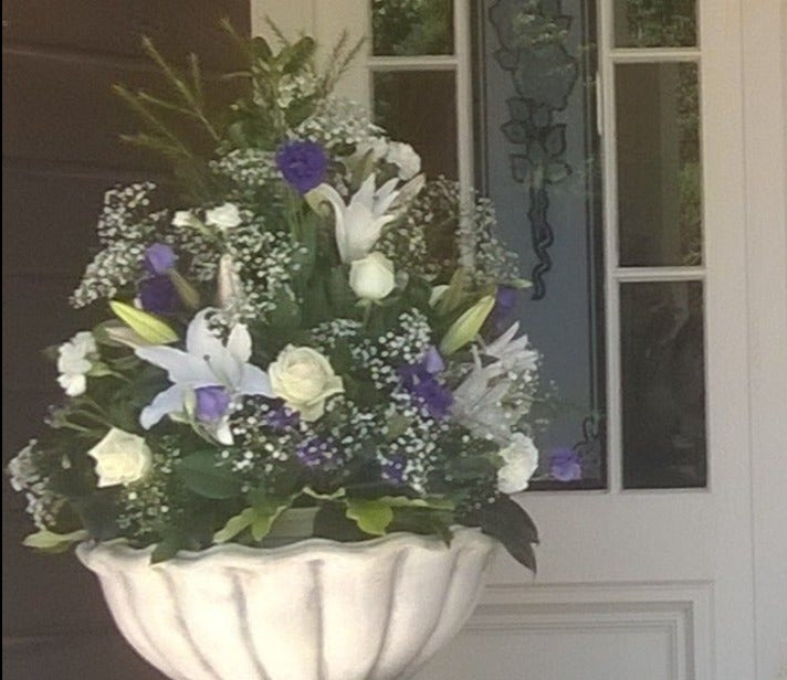 Flower arrangement white lilies, white roses, blue flowers, gyp