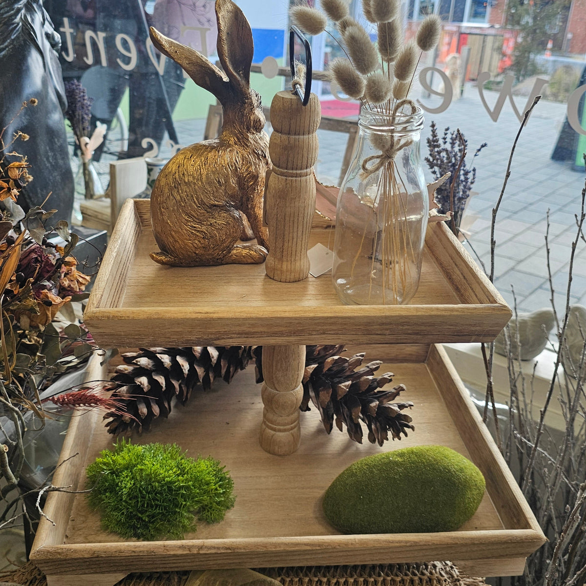 A two-tier wooden decorative tray stand