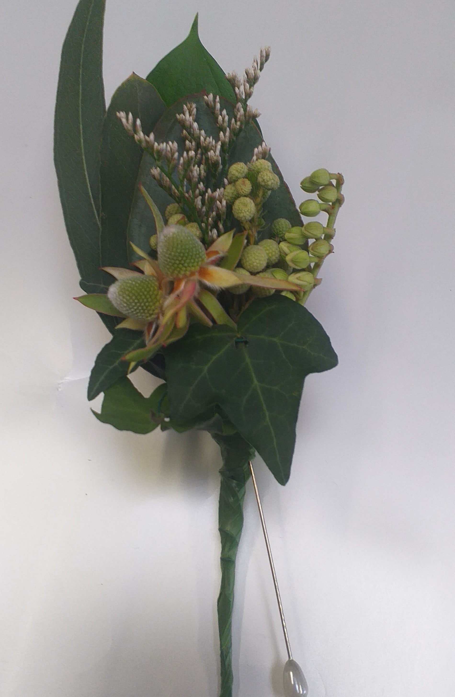 Buttonhole no flowers. leuc buds, pieris buds, limonium, gum leaves, ivy leaves