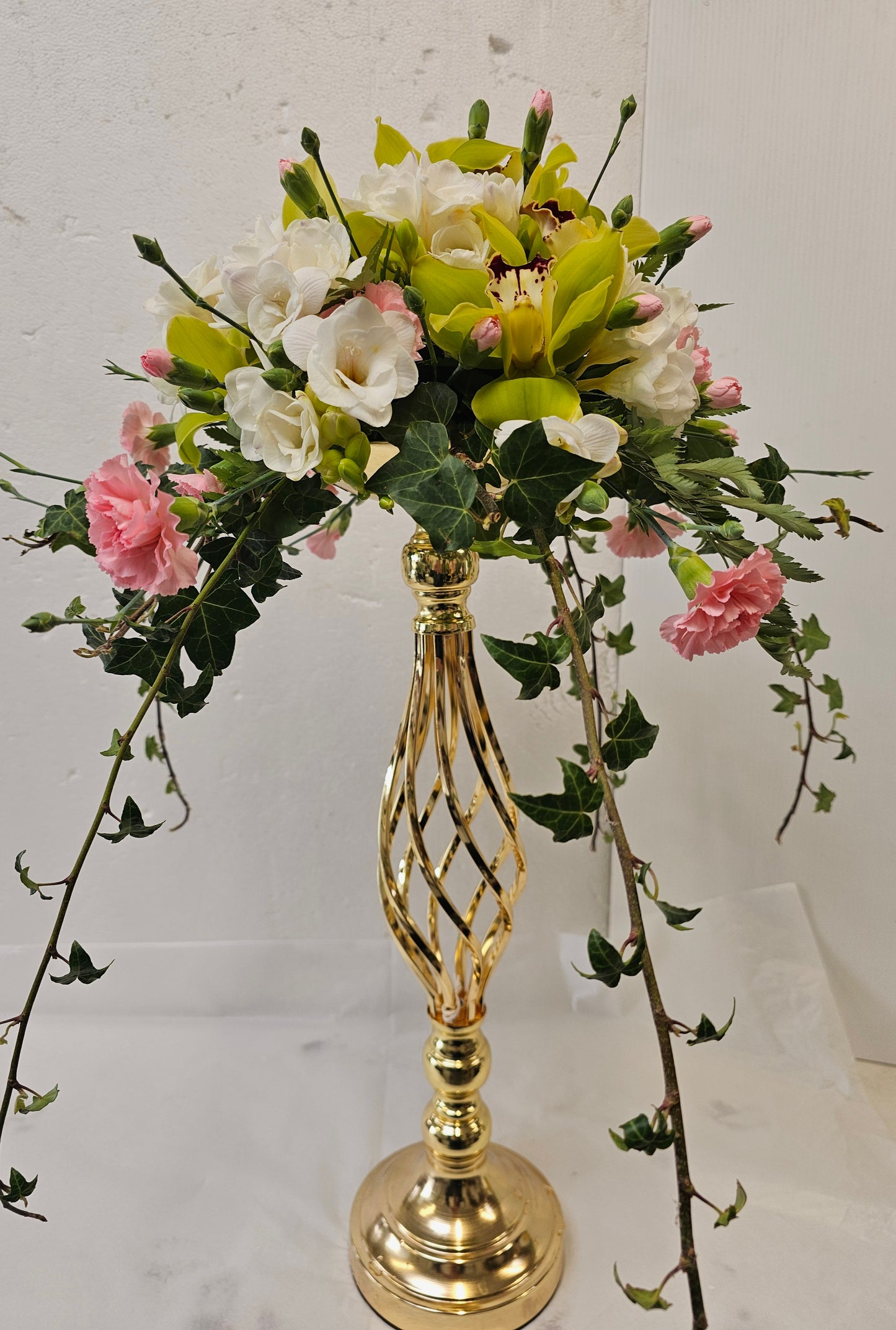 Flower Arrangement on top of a gold candlestick (candlestick extra)