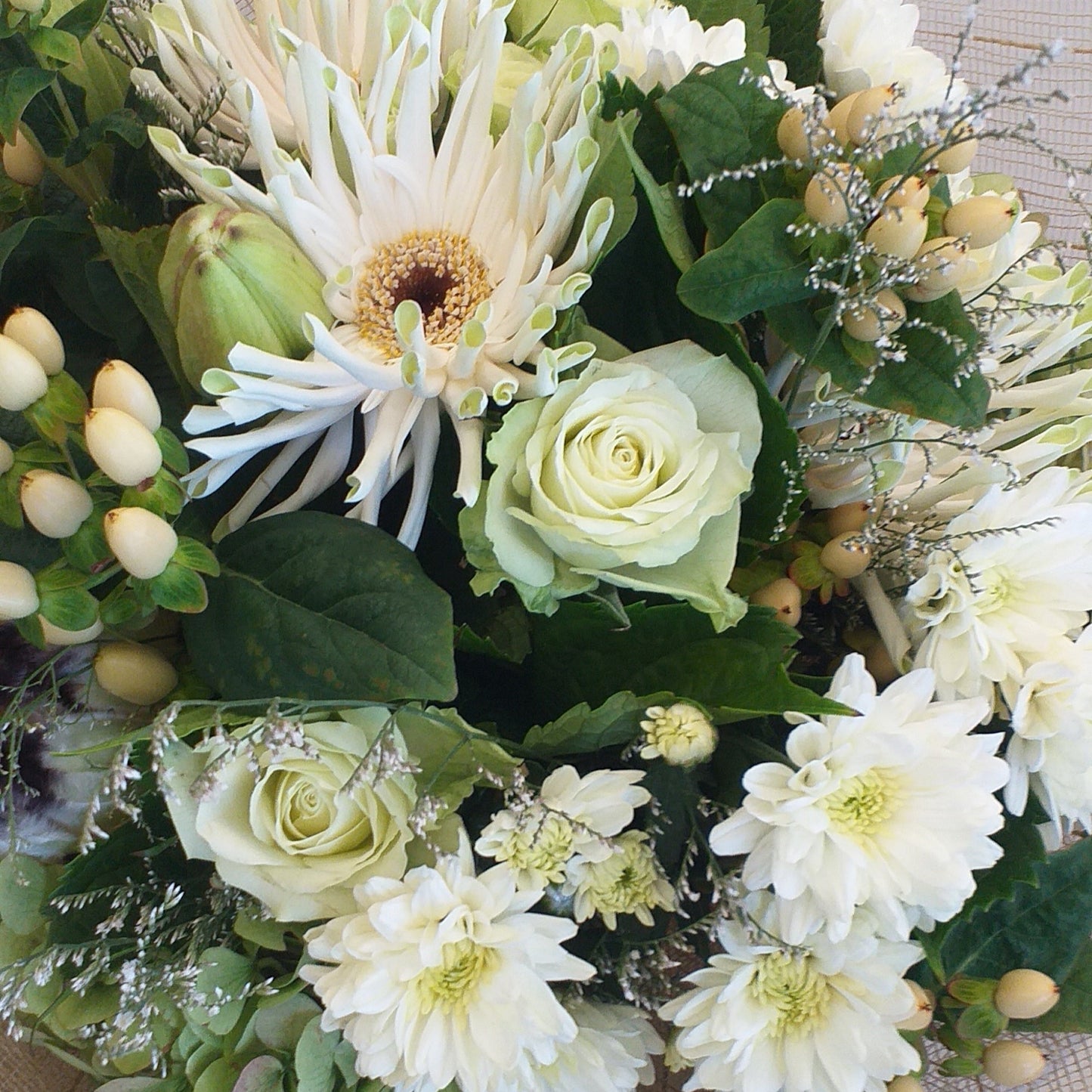 cream gerberas, chrysies, limonium and berries, green roses and hydrangea