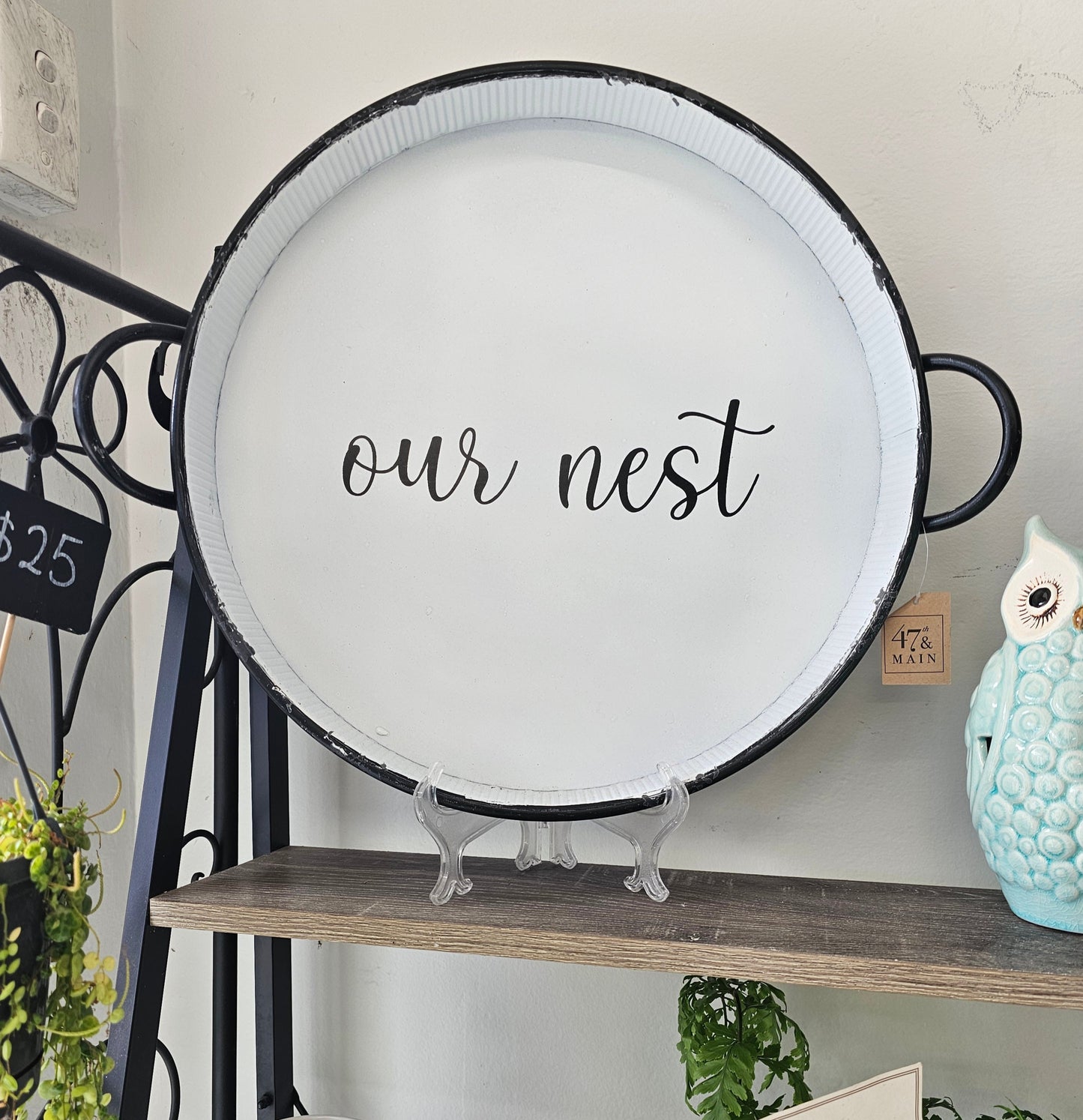 Decorative tray with 'our nest' text