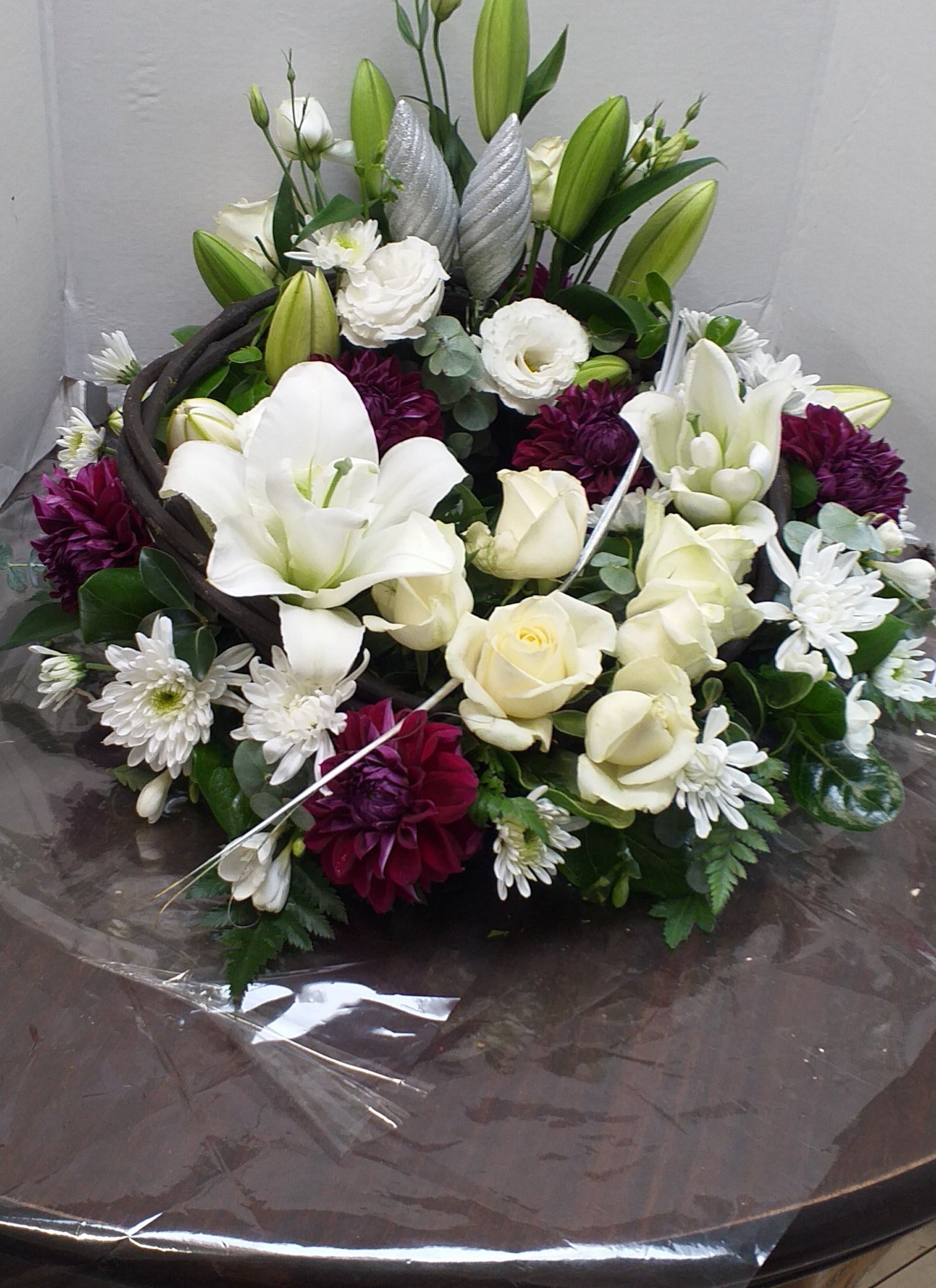 Arrangement in a bowl suitable for a table or pedestal, in white and red flowers