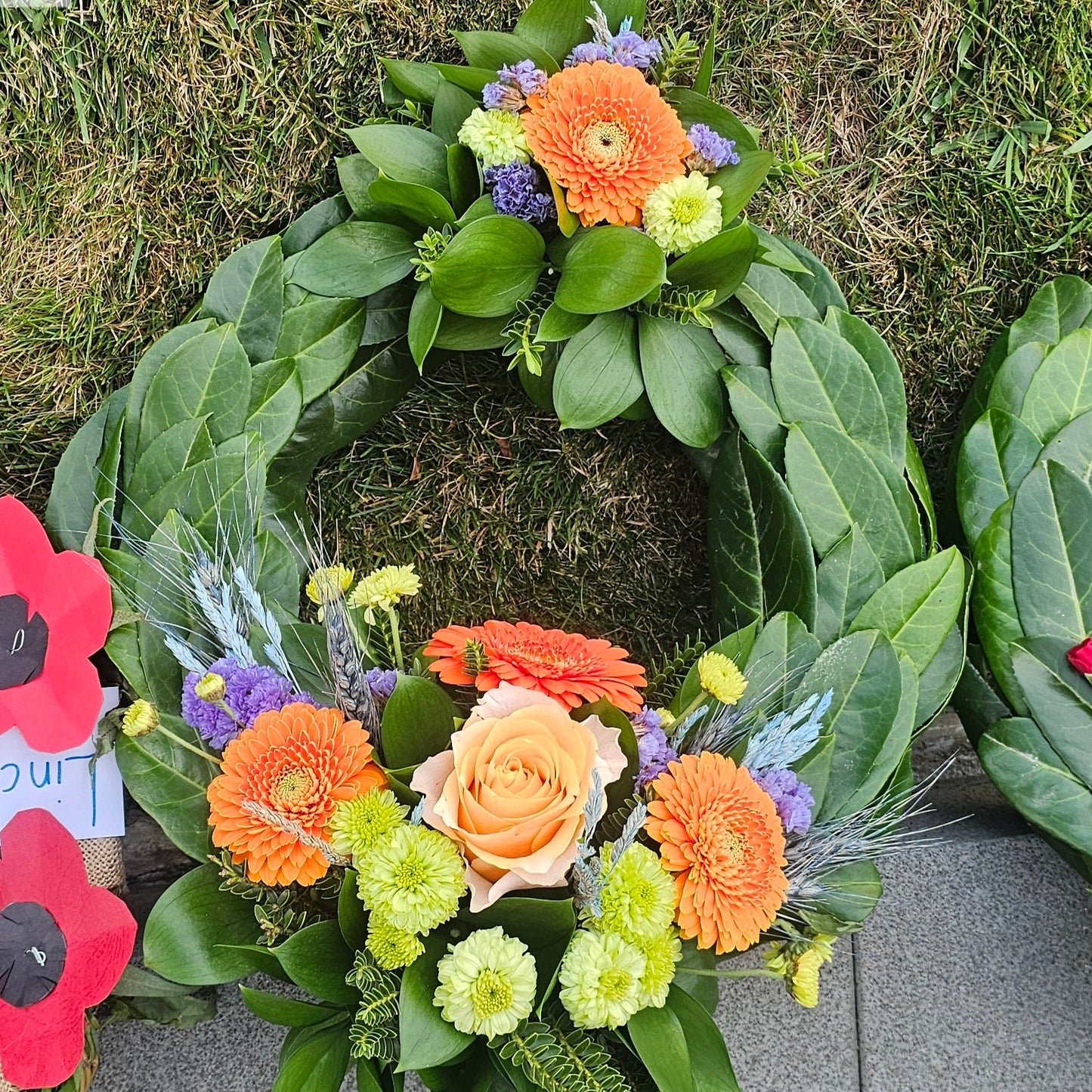 Anzac style wreath in apricot /orange and blue/purple