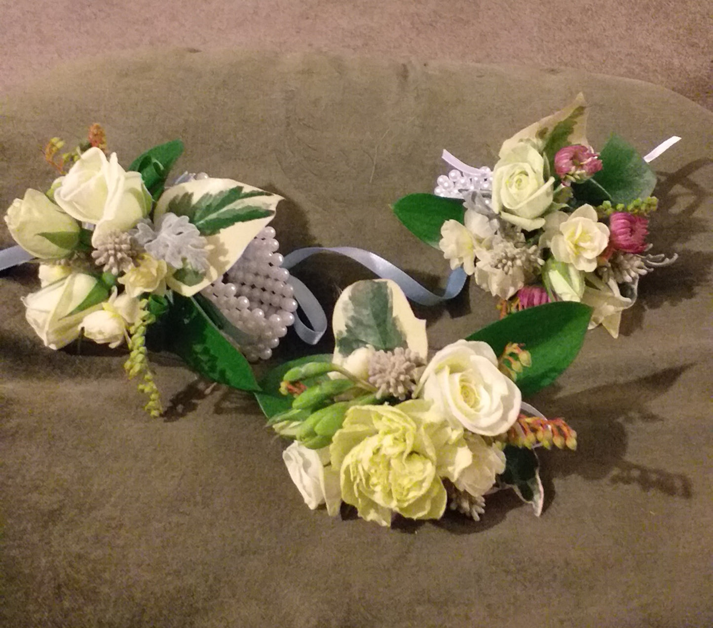 selection wrist corsages with mini roses spray carnations, chrysies, pieris,