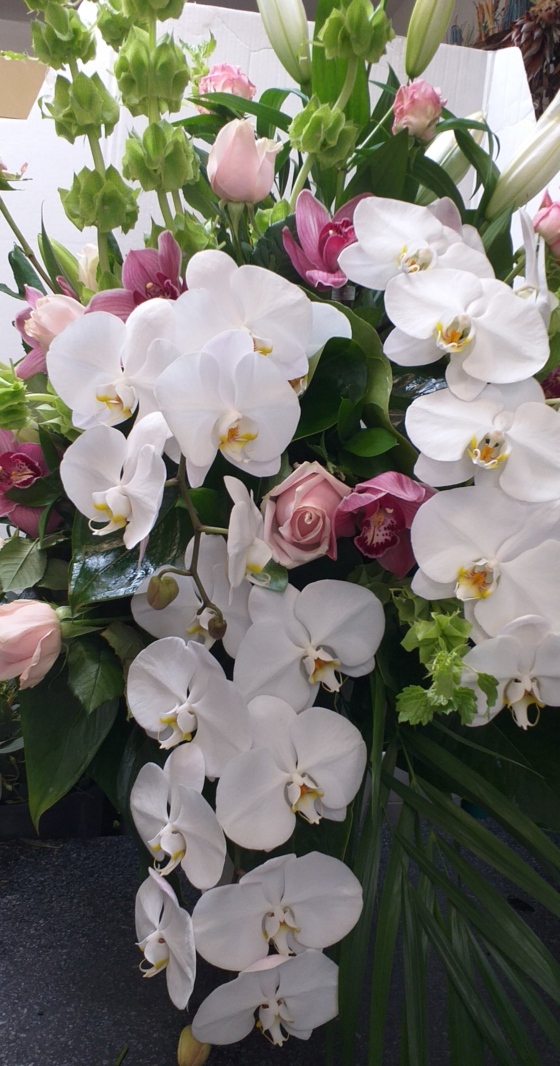 Wedding Flowers Reception Decorations -lovely arrangement of phalaenopsis stems roses and cymbidium orchid flowers.  Broadfield Flowers Florist Lincoln