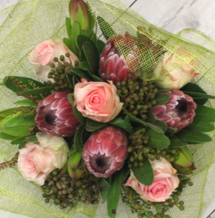 PROTEA BEAUTY pink, red, protea, green leucs, pink roses, berzellia netting, berries Broadfield Flowers Florist Lincoln