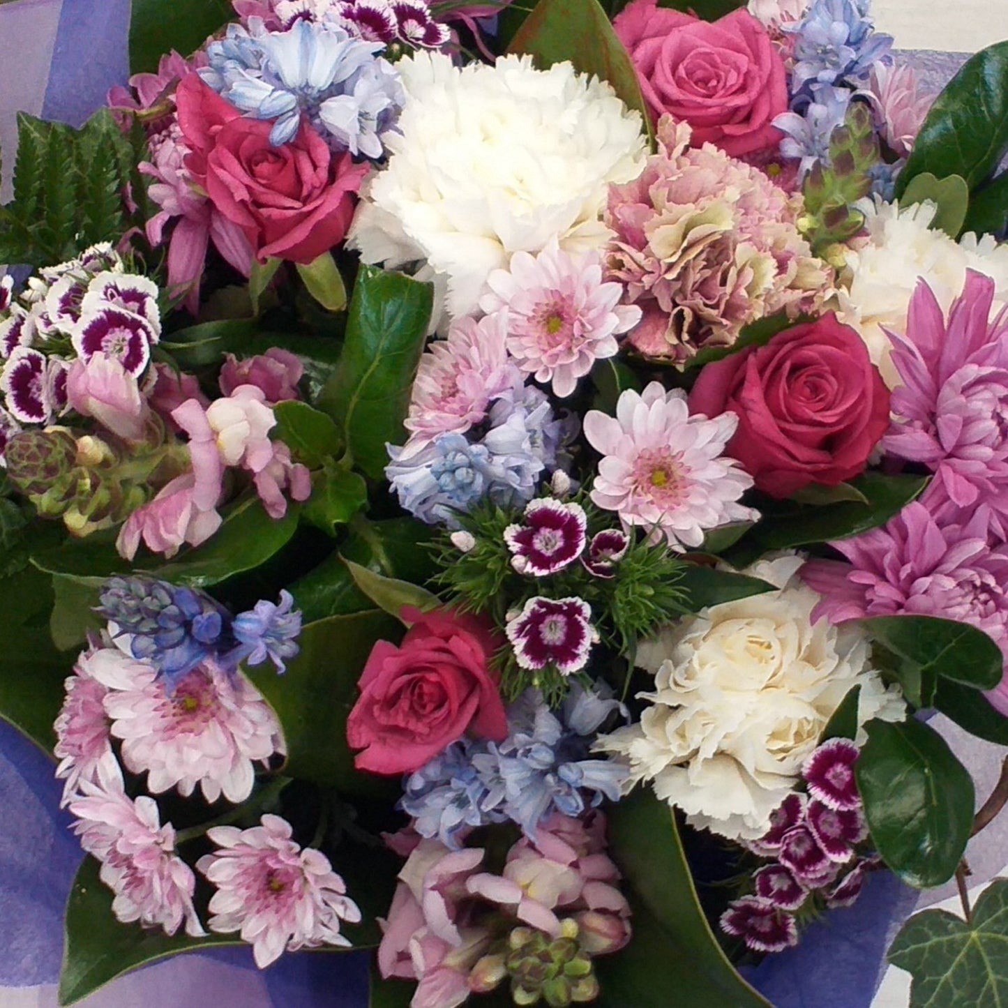 A bouquet of small flowers, sweet william, spray chrysanthemums, snaps, roses, this photo has hyacinths, but they are seasonal