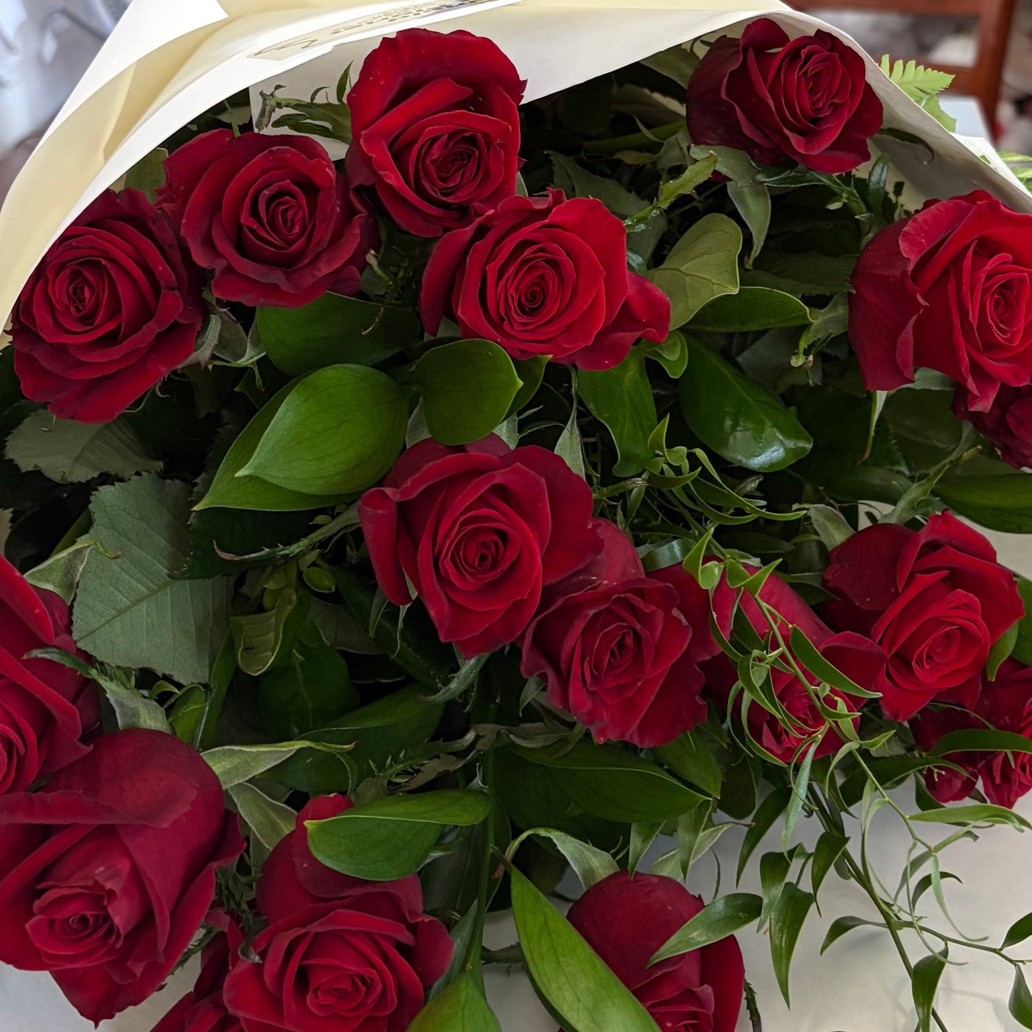 Bouquet of red roses in a white wrap 