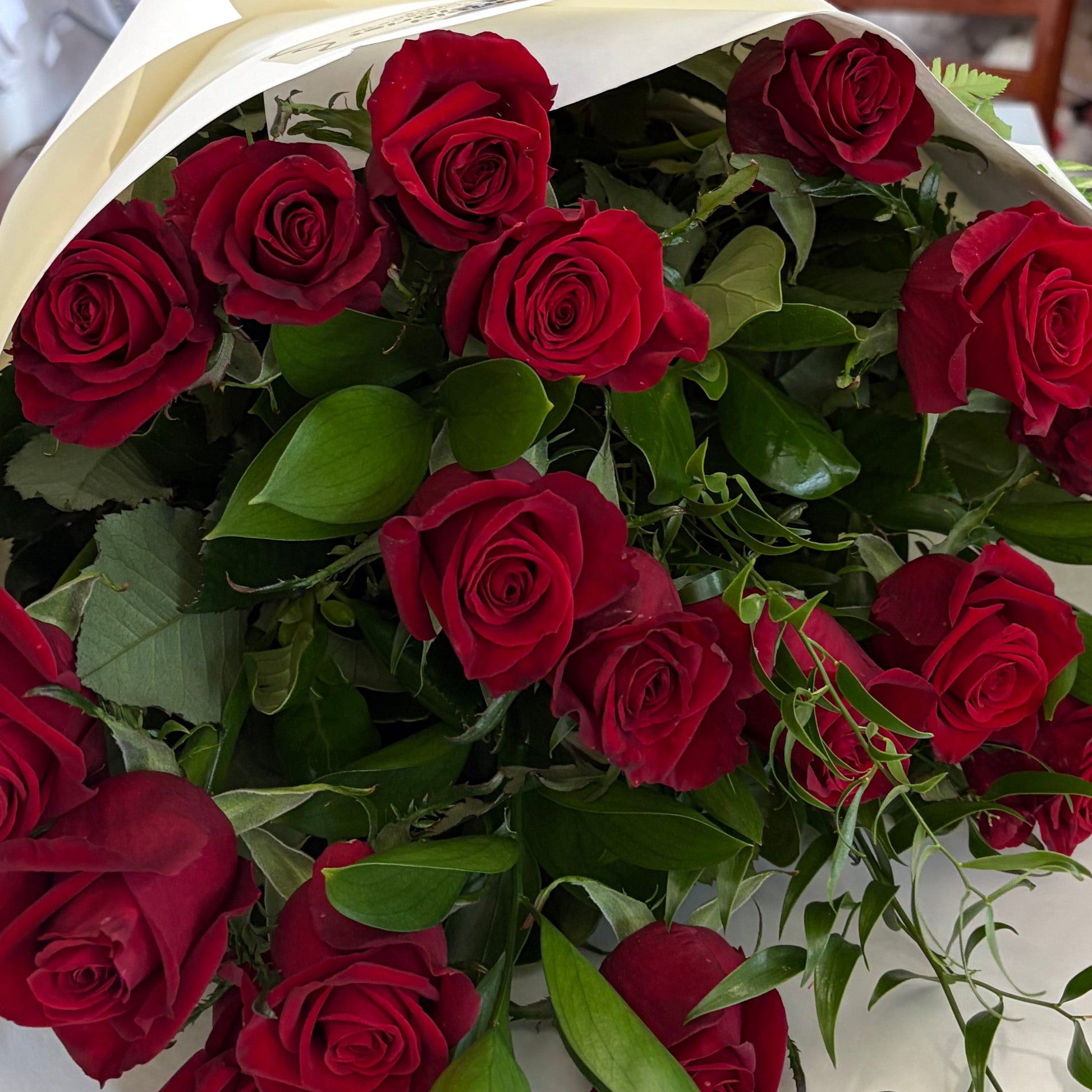 Bouquet of red roses in a white wrap 