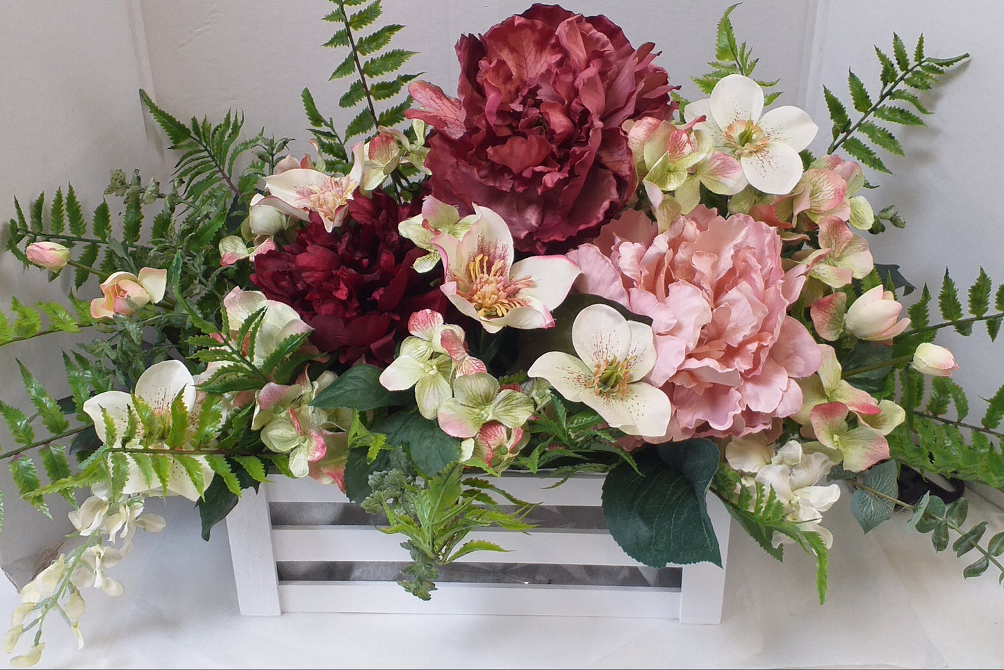 peach, pink, red silk flowers in a box