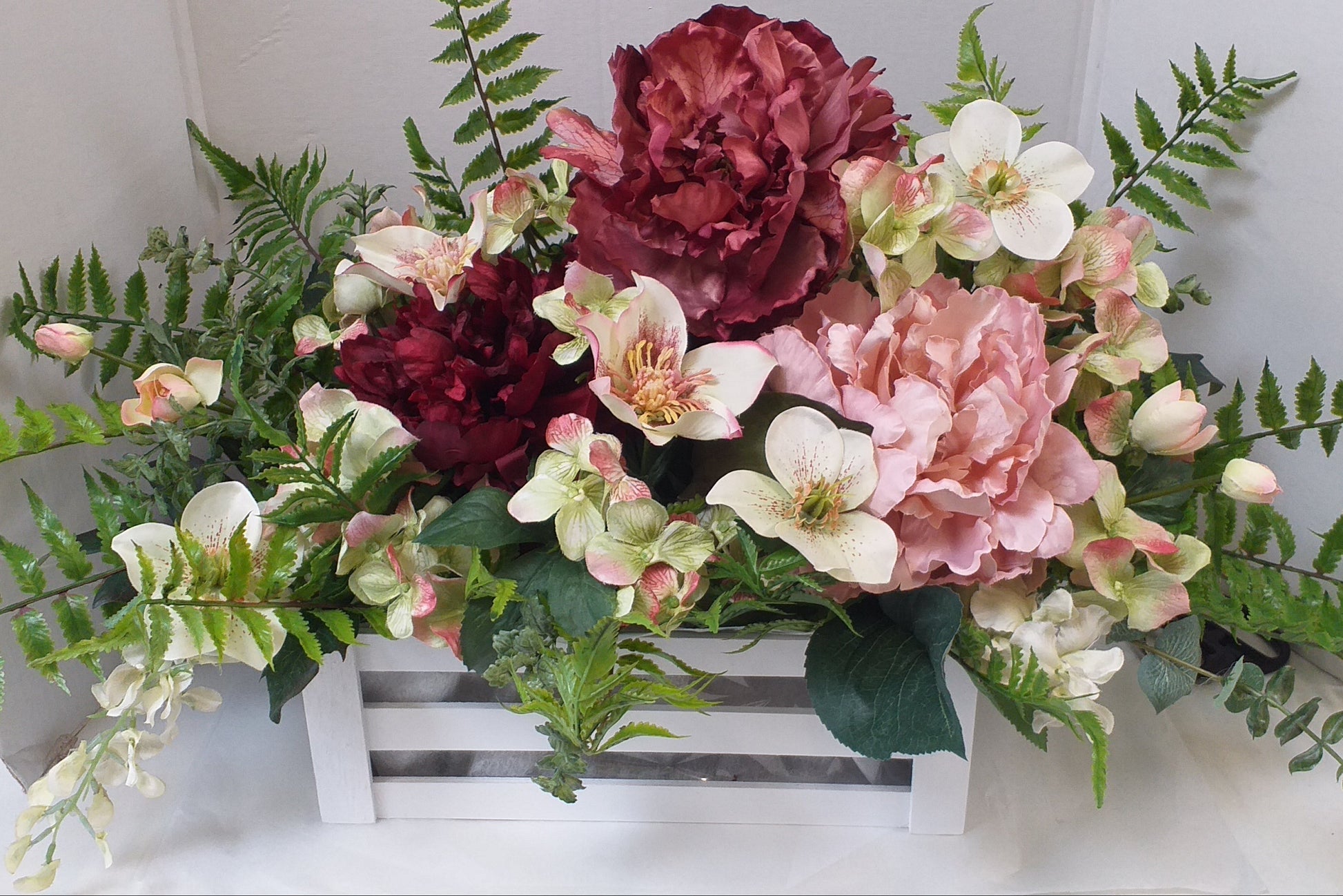 peach, pink, red silk flowers in a box