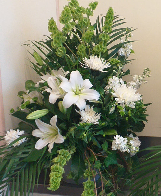 Arrangement with white lilies, chrysies, stock green balm and leaves