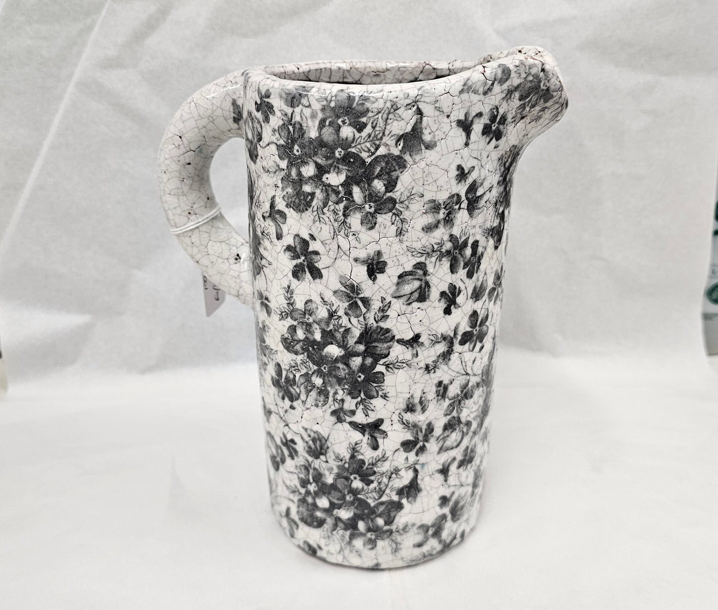 Cream ceramic jug with dark grey floral decoration. Great for home decoration with cut flowers or as an attractive decorative piece on its own
