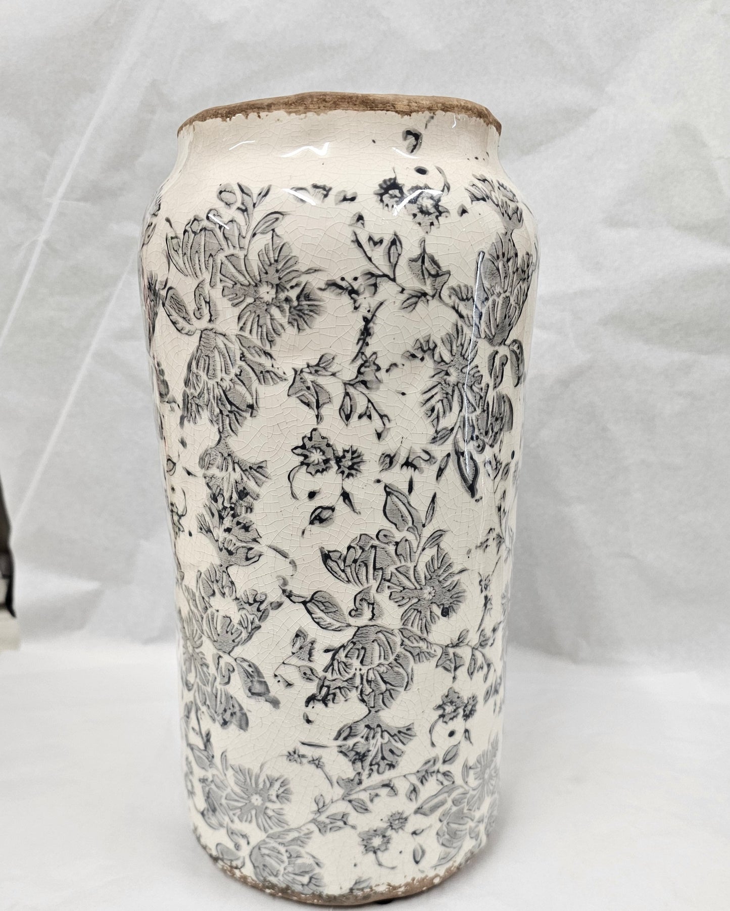 White ceramic urn with dark grey floral design