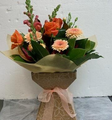 bright box in a water filled container, orange and apricot flowers