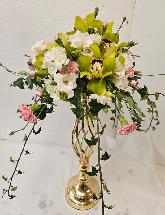 Flower Arrangement on top of a gold candlestick (candlestick extra)