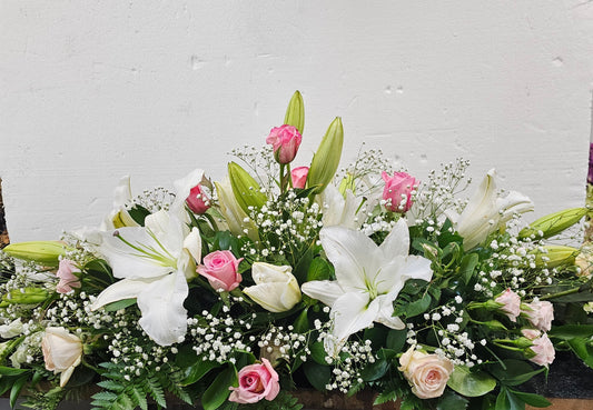 casket spray white lilies, pink roses, pink spray roses and gyp