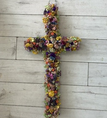 cross made of oasis foam and decorated with dried flowers