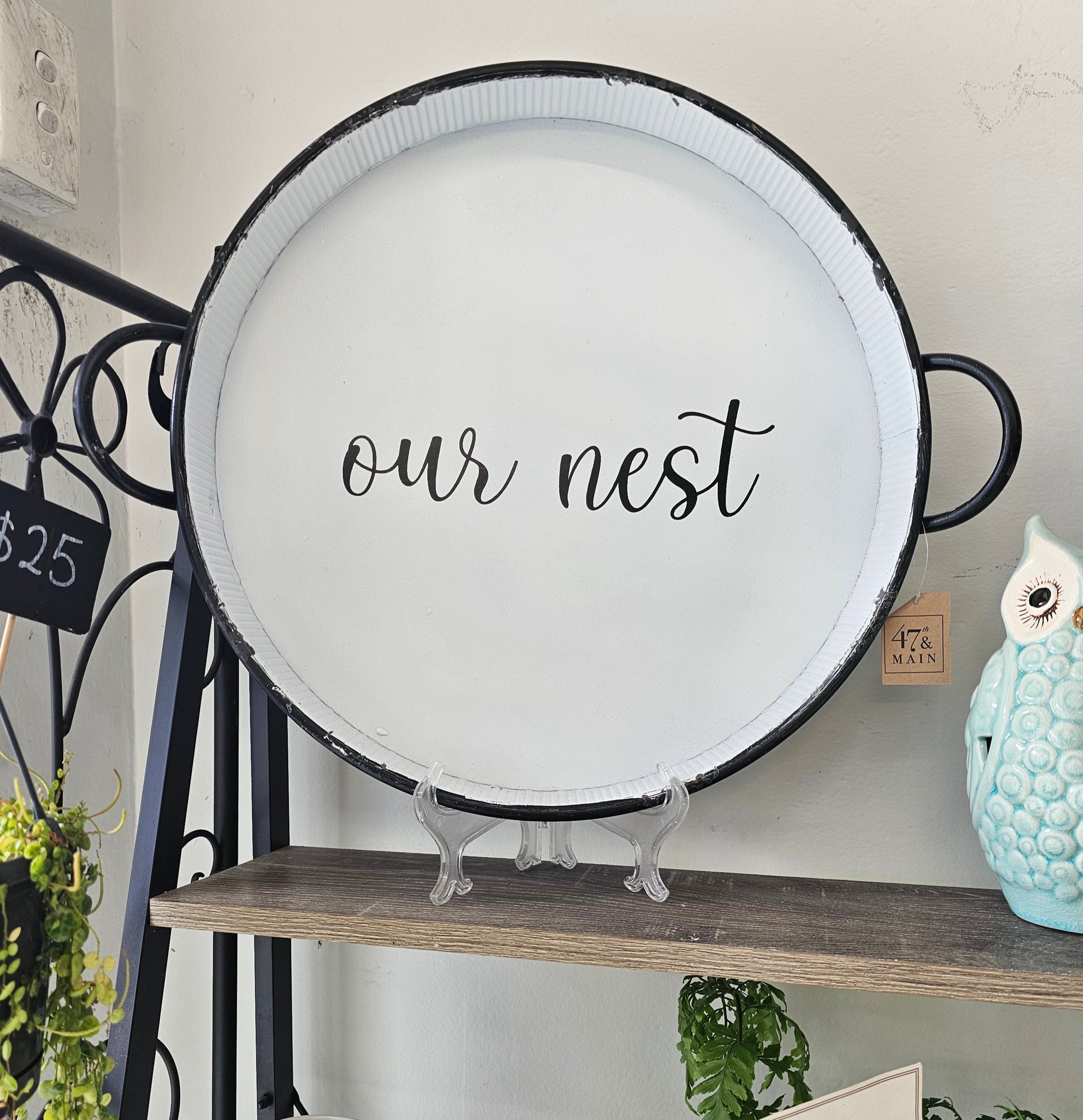 Decorative tray with 'our nest' text 