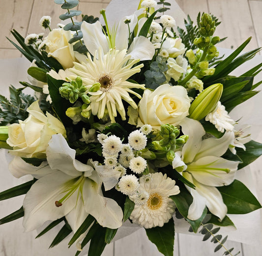 White bouquet, white gerbera, white roses, stock, chrysies, lilies, gum, leather fern large leaves