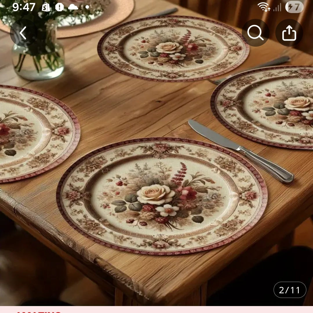 four round decorative plate mats with floral bouquet patterns on a wooden table