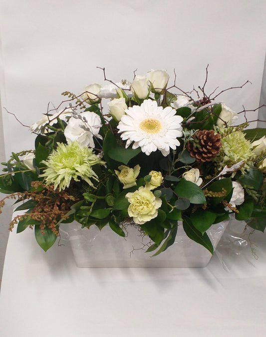 White mini roses, gerberas, green chrysies, spray carnation and cones