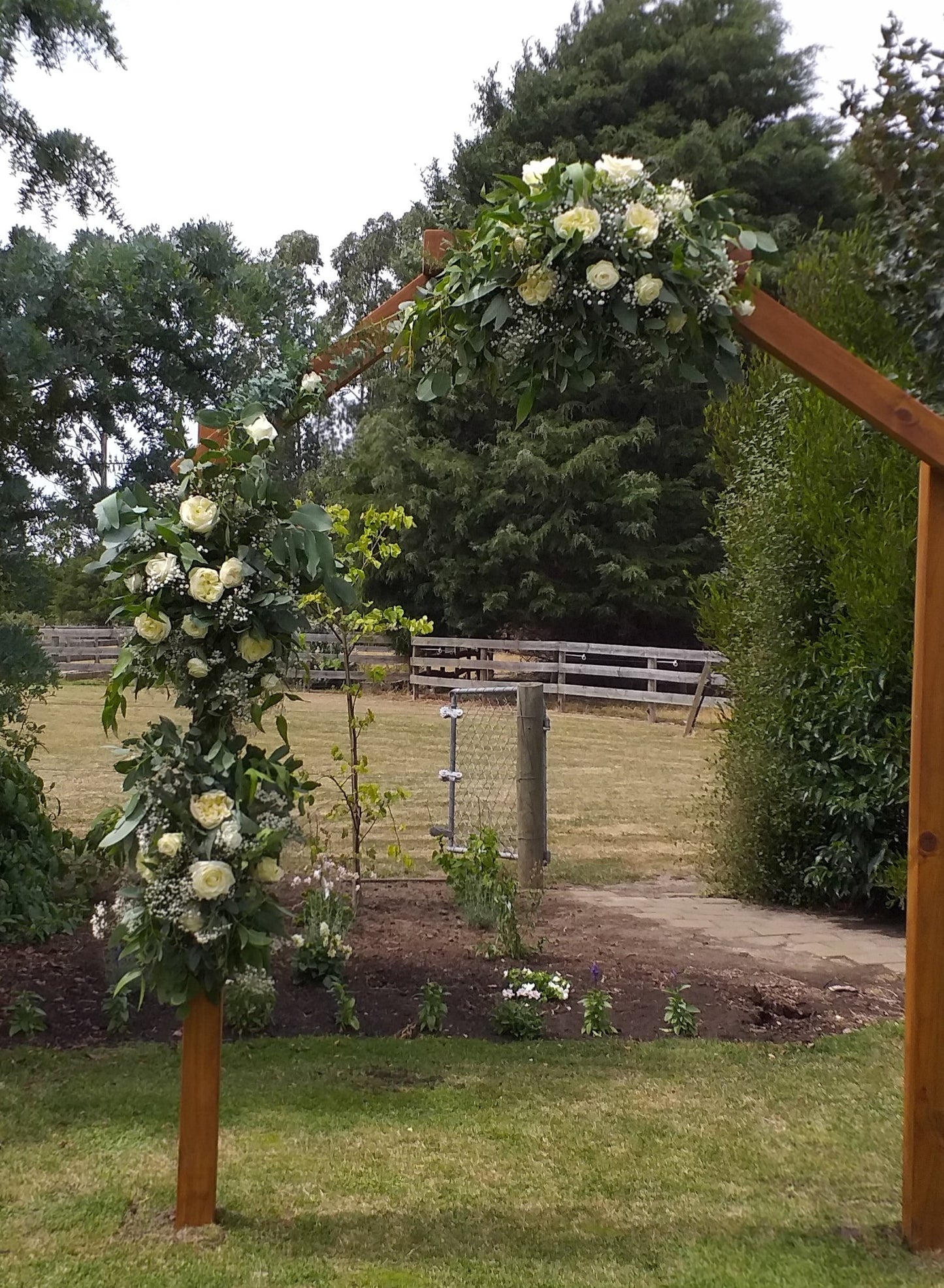 Decorated archway, 3 arrangements attached to a wooden archway, flowers included, cream roses, white spray roses, gypsophilla and foliage