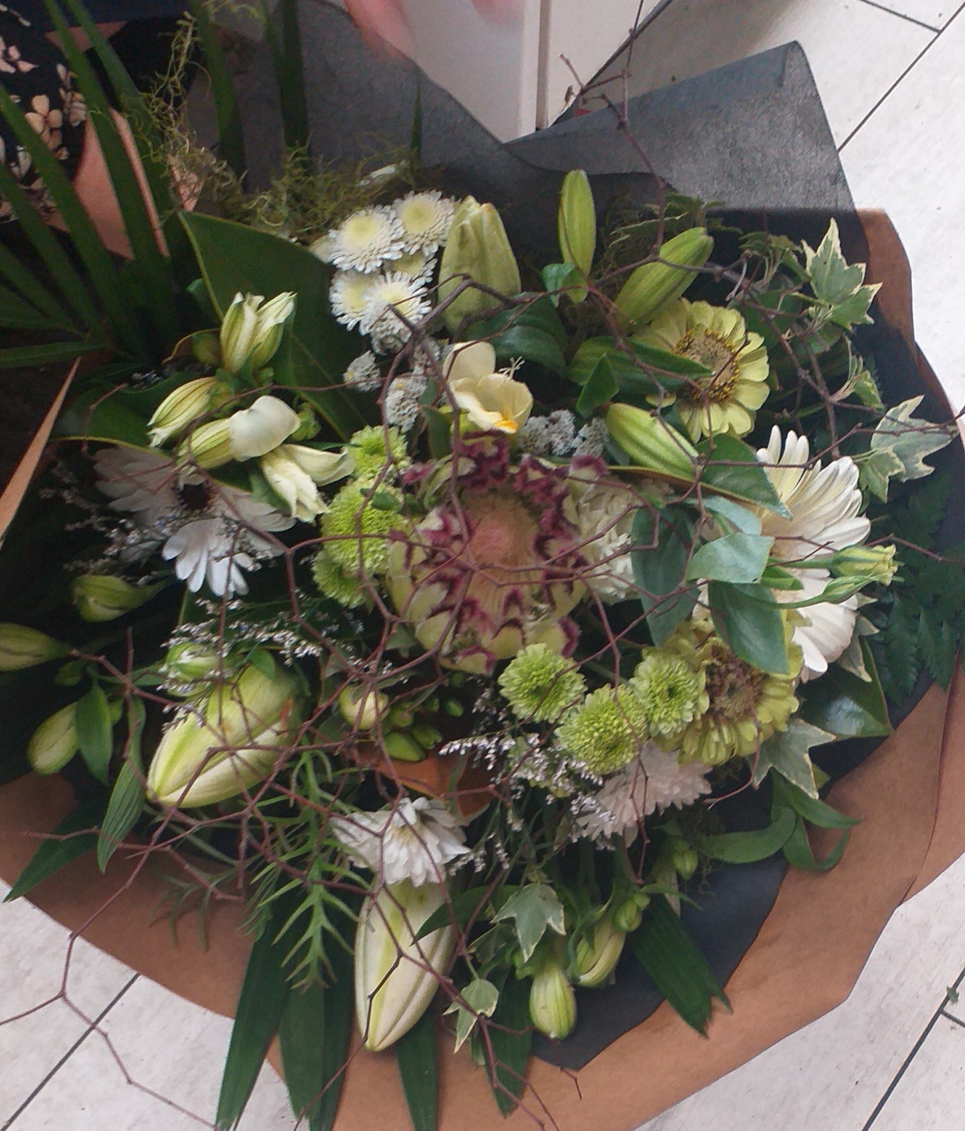 Bouquet of protea, spray chrysanthemums, lilies, zinnia, molenbeckia, freezias