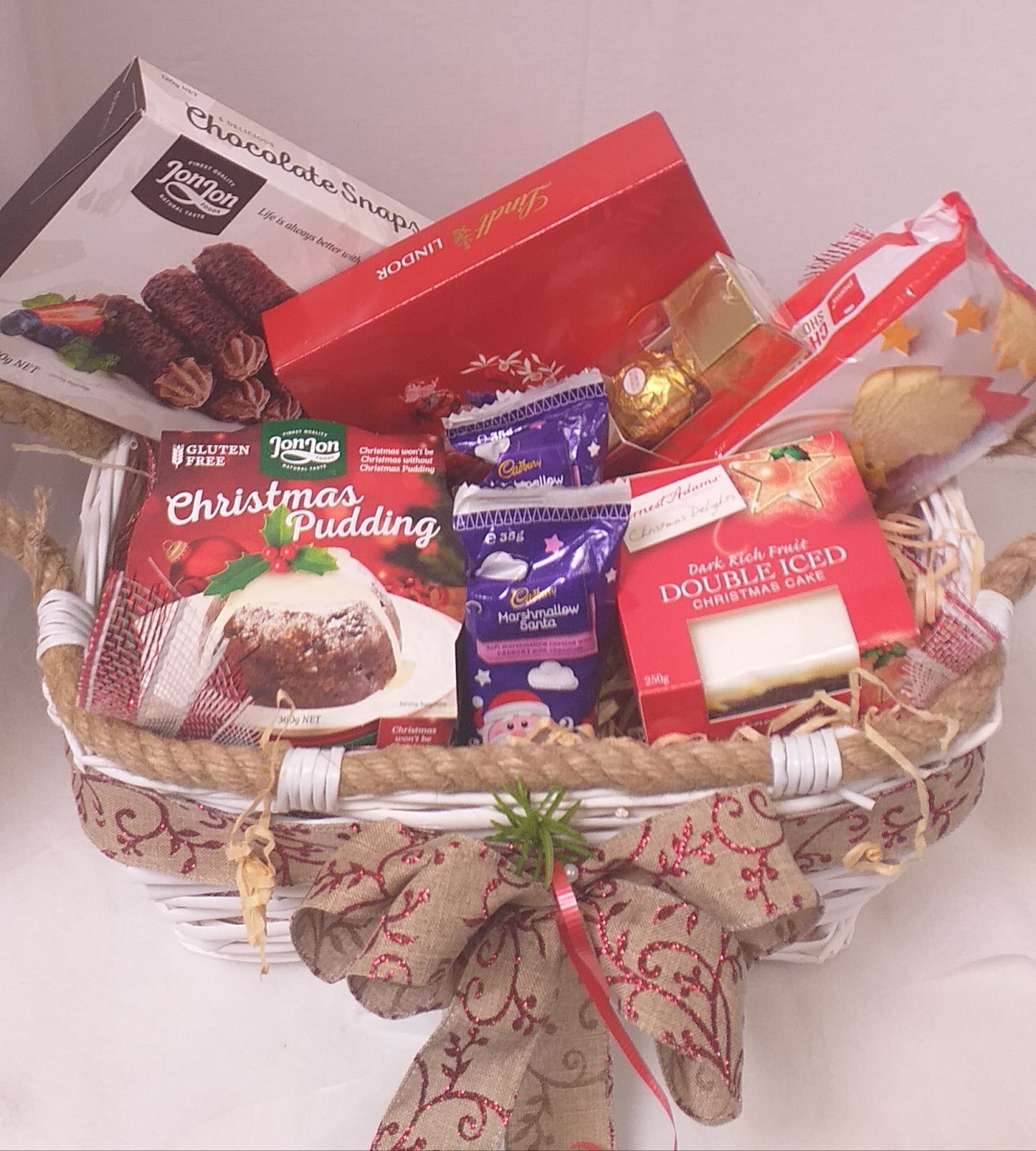 Christmas Basket - pudding, cake, chocolate snaps, shortbread shapes, chocolates, choclate marshmallow santas, in a tray  