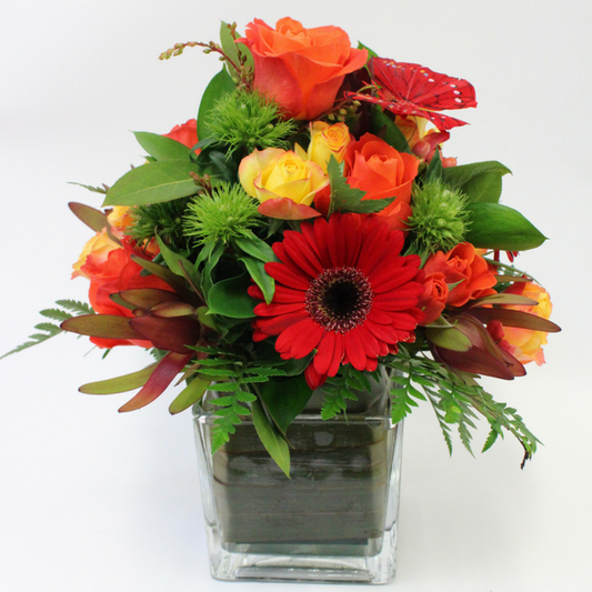 Arrangement in a Vase in yellow, orange, red and green. roses, gerberas, roses, leucs and butterflies - Broadfield Flowers Florist Lincoln