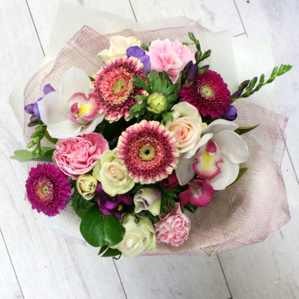 Pretty Posy - with gerberas,freezia, anenomes, carnations, roses and orchids in season