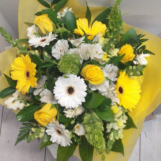 Fresh as Spring flower bouquet, yellow gerberas, bells of ireland, snap dragons, yellow roses, fern, alstroemeria, early cheer, wrapped in yellow