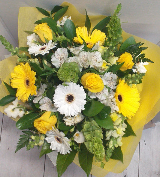 Fresh as Spring flower bouquet, yellow gerberas, bells of ireland, snap dragons, yellow roses, fern, alstroemeria, early cheer, wrapped in yellow